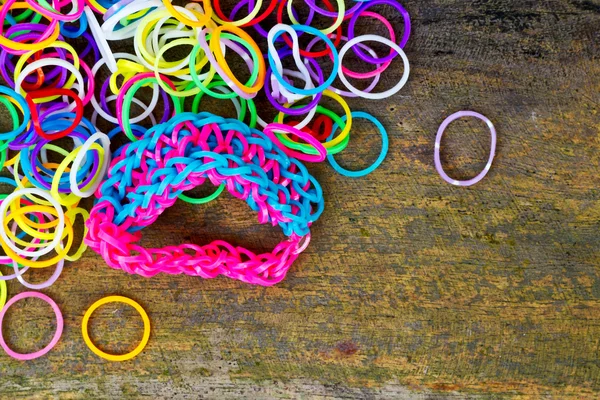 Colorful Rainbow loom bracelet rubber bands fashion on old wood - Stock  Image - Everypixel